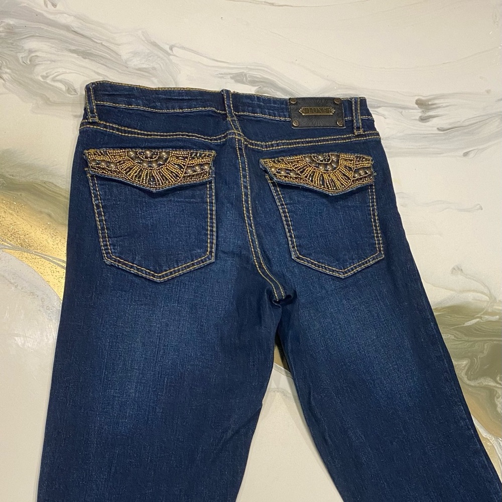 Vintage low waisted tru luxe flared jeans with bedazzled pockets